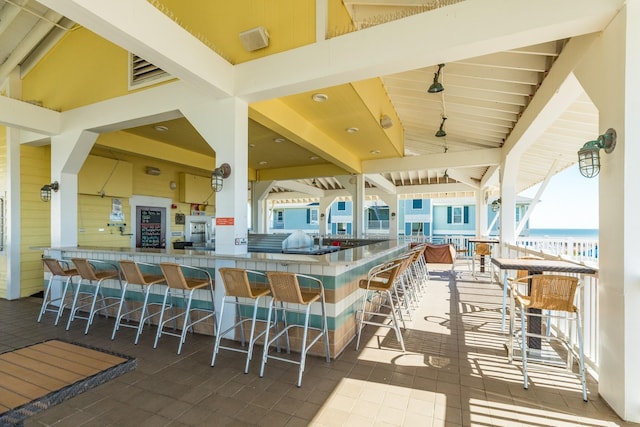 view of patio / terrace with a water view and an outdoor bar