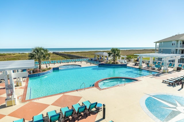 view of swimming pool featuring a pergola, a patio area, a hot tub, and a water view