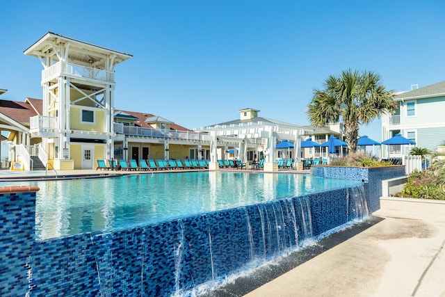 view of pool featuring a pergola, a patio, and pool water feature