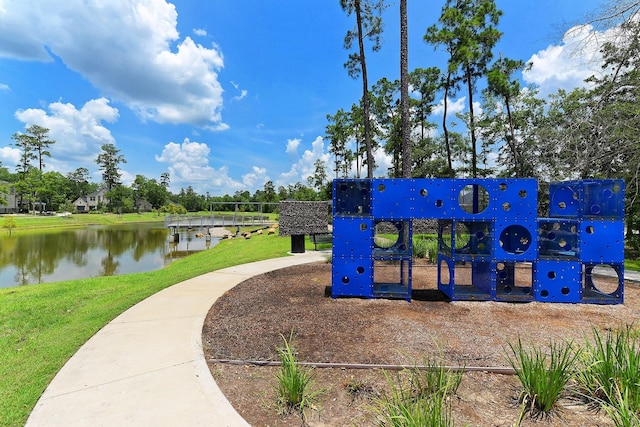 view of property's community featuring a playground and a water view