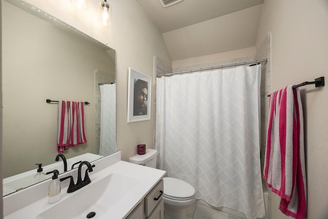 bathroom featuring vanity, vaulted ceiling, toilet, and walk in shower