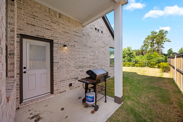 view of exterior entry with a lawn