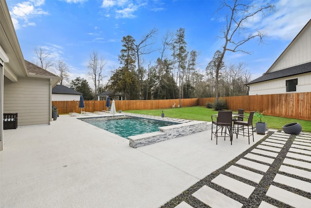 view of pool with a patio and a yard