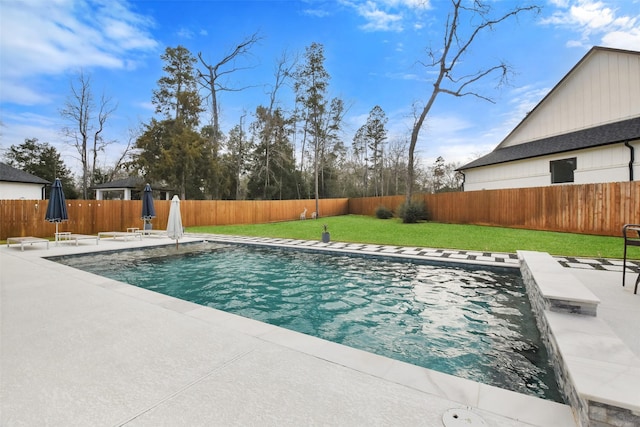 view of swimming pool with a yard and a patio area