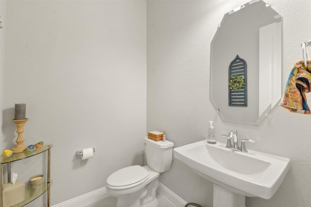 bathroom featuring sink and toilet