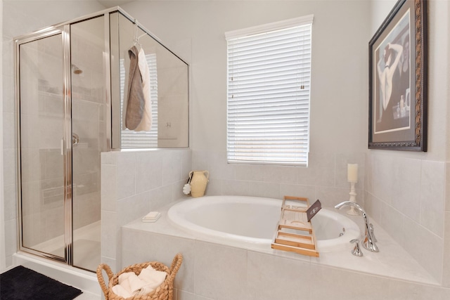 bathroom featuring separate shower and tub