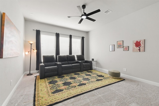 carpeted living room with ceiling fan