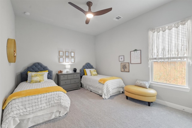 bedroom with multiple windows, carpet, and ceiling fan