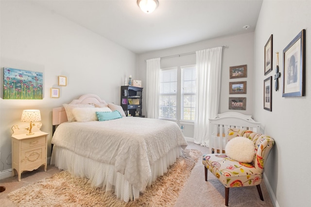 bedroom featuring light carpet