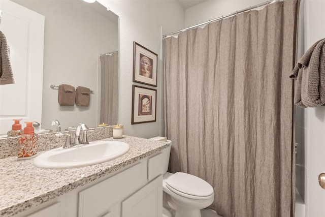 bathroom featuring toilet and vanity