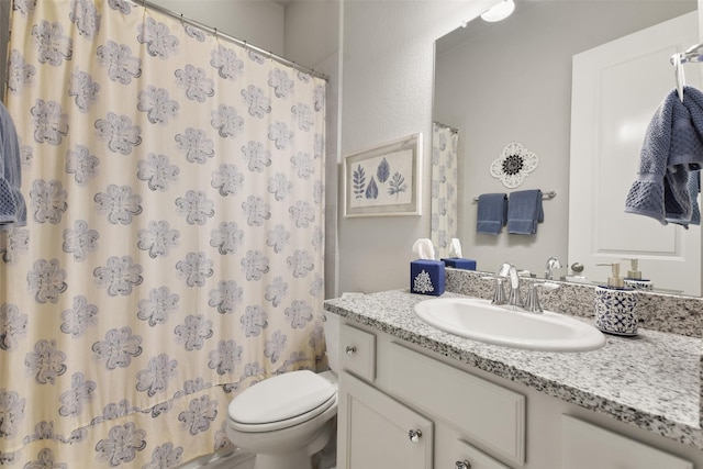 bathroom with toilet and vanity