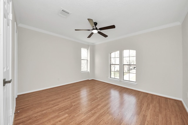 unfurnished room featuring ceiling fan, light wood-type flooring, and crown molding