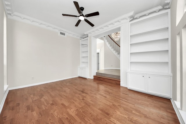 interior space with ceiling fan, light wood-type flooring, crown molding, and built in features