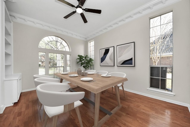 dining area with ceiling fan, dark hardwood / wood-style flooring, and ornamental molding