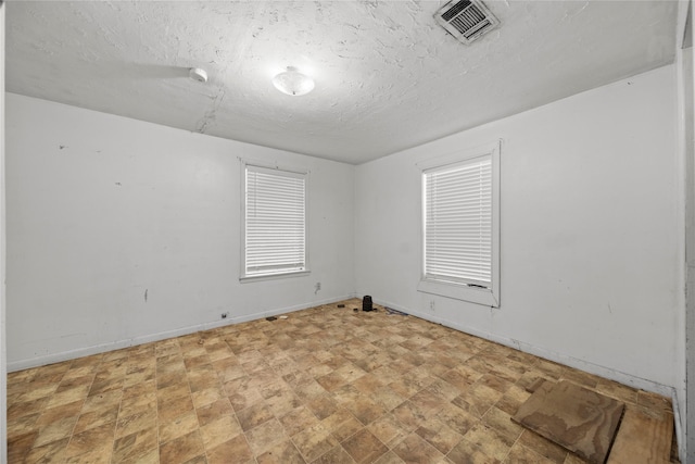 spare room with a textured ceiling