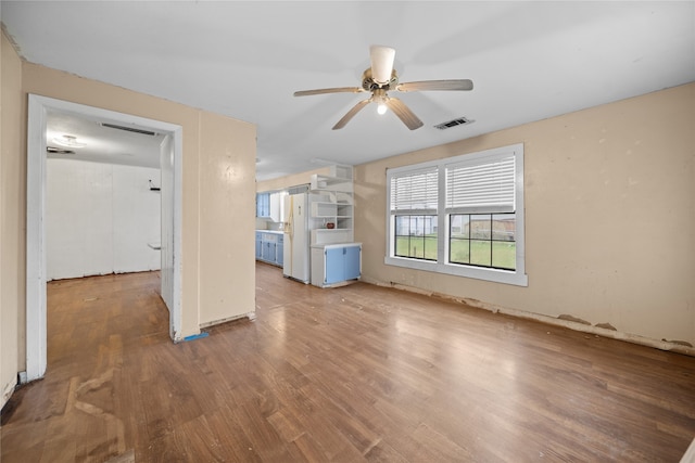 unfurnished living room with hardwood / wood-style flooring and ceiling fan