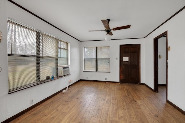 interior space featuring ornamental molding, hardwood / wood-style floors, ceiling fan, and cooling unit