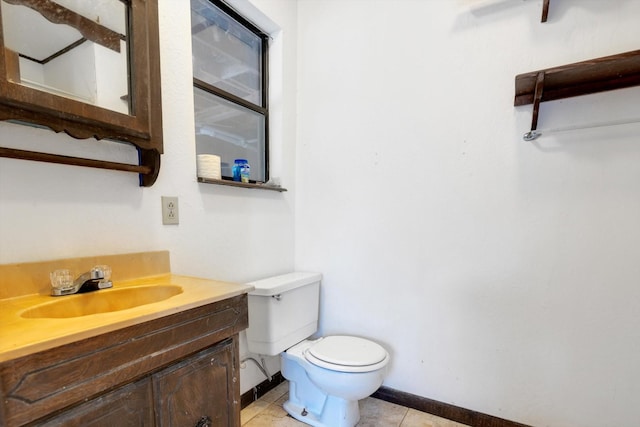 bathroom with vanity, toilet, and tile patterned flooring