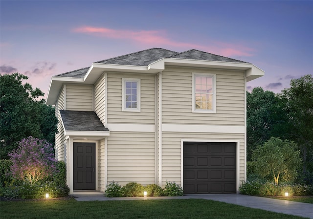 traditional home with a garage, driveway, and roof with shingles