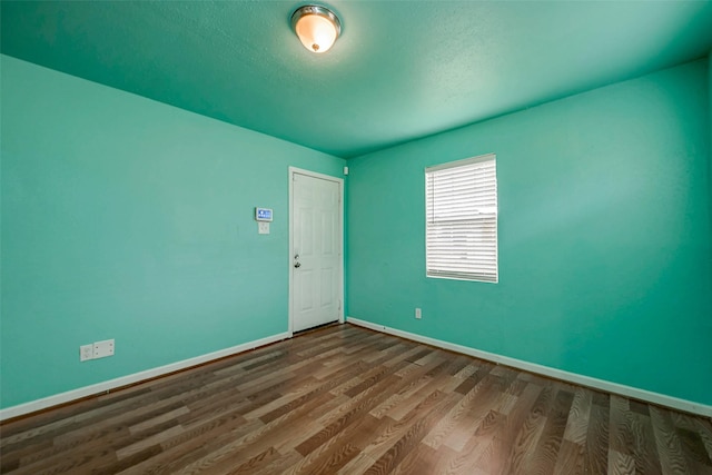 spare room with hardwood / wood-style floors