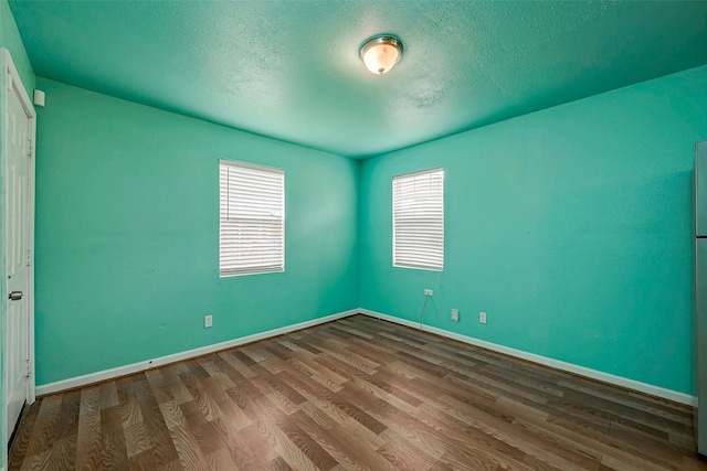 unfurnished bedroom with hardwood / wood-style flooring and a textured ceiling