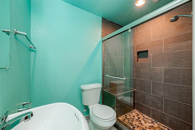 bathroom featuring a shower with shower door and toilet