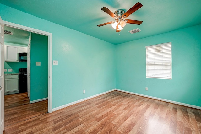 unfurnished room with ceiling fan and light hardwood / wood-style flooring