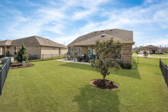 rear view of house with a lawn and a patio area