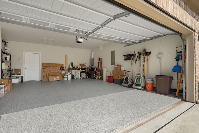 garage with a garage door opener and electric panel