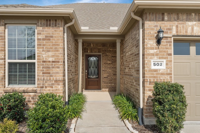 doorway to property with a garage