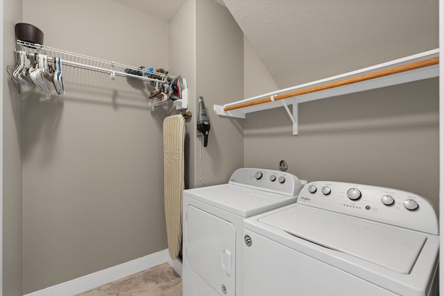 washroom with light tile patterned flooring and washer and clothes dryer