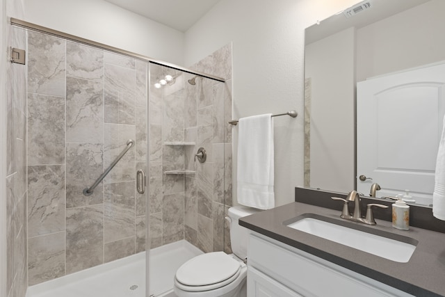 bathroom with vanity, toilet, and an enclosed shower