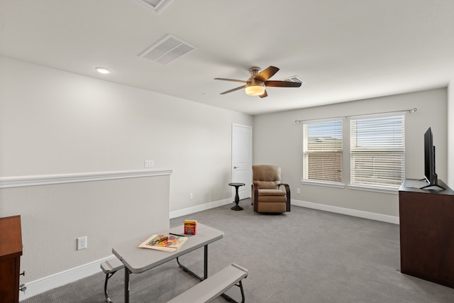 sitting room featuring light colored carpet and ceiling fan