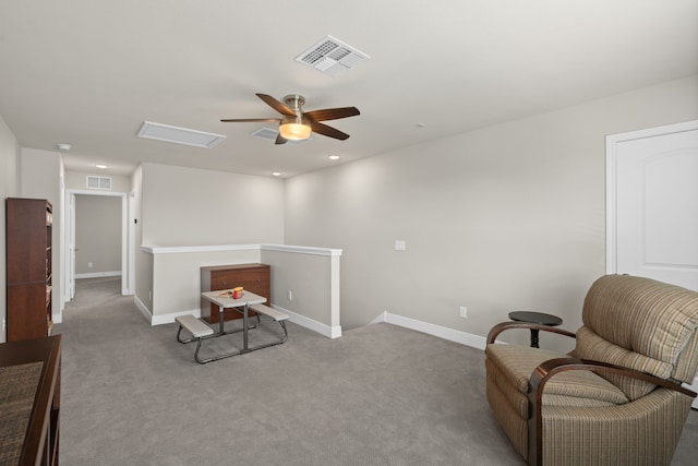 sitting room featuring light colored carpet