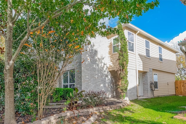 view of side of home featuring a lawn