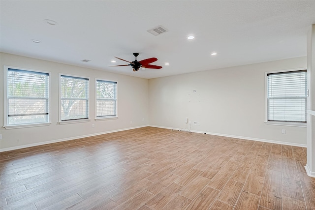 spare room featuring ceiling fan and light hardwood / wood-style floors