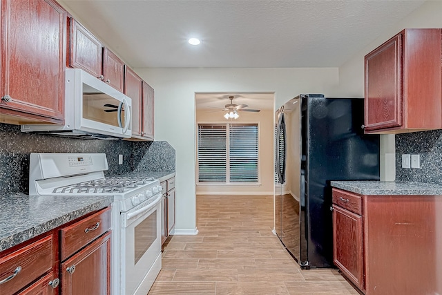 kitchen featuring white appliances, ceiling fan, backsplash, light hardwood / wood-style floors, and a textured ceiling