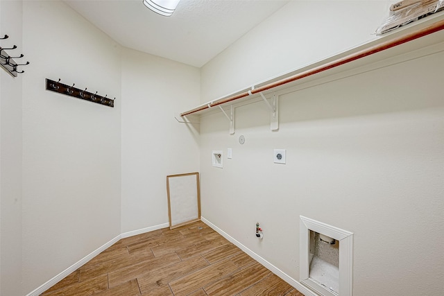 washroom featuring gas dryer hookup, washer hookup, light hardwood / wood-style floors, and hookup for an electric dryer