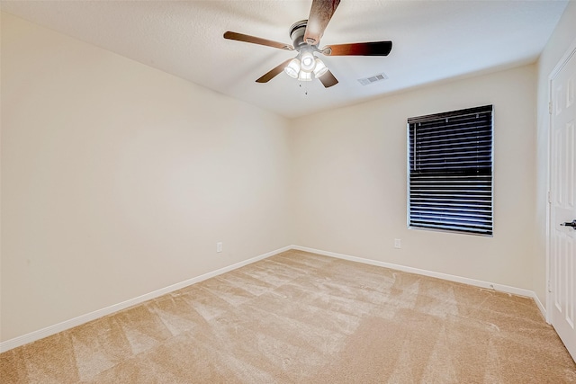 unfurnished room with light colored carpet and ceiling fan