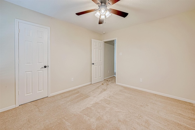 unfurnished bedroom featuring light carpet and ceiling fan