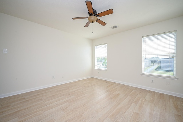 unfurnished room with ceiling fan and light wood-type flooring