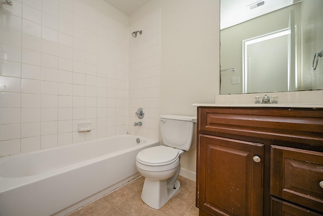 full bathroom featuring tiled shower / bath, tile patterned floors, toilet, and vanity