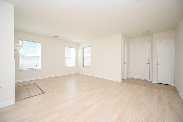 spare room with light hardwood / wood-style floors