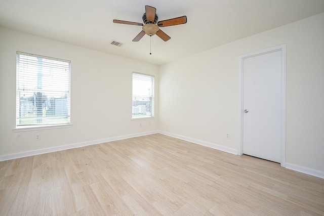 empty room with ceiling fan and light wood-type flooring