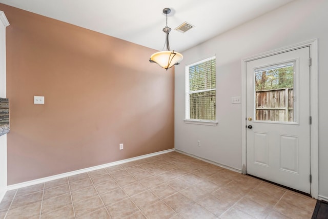 unfurnished dining area with light tile patterned floors