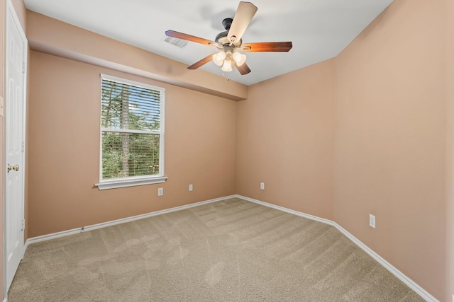 unfurnished room with light colored carpet and ceiling fan