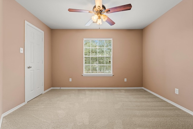 spare room with light carpet and ceiling fan