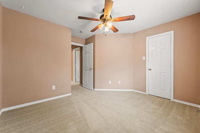 empty room featuring light carpet and ceiling fan