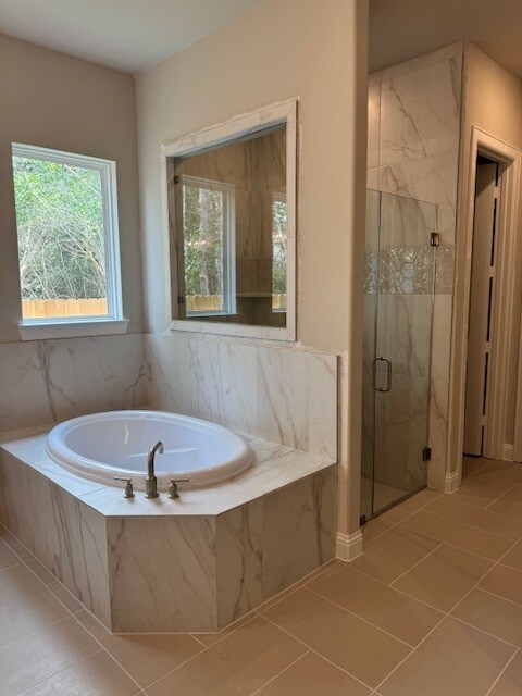 16147 Rustling Woods Rd, Conroe, TX 77302 - full bathroom featuring a marble finish shower, a garden tub, and tile patterned floors