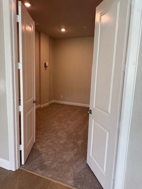 16147 Rustling Woods Rd, Conroe, TX 77302 - hall featuring baseboards, carpet floors, and recessed lighting